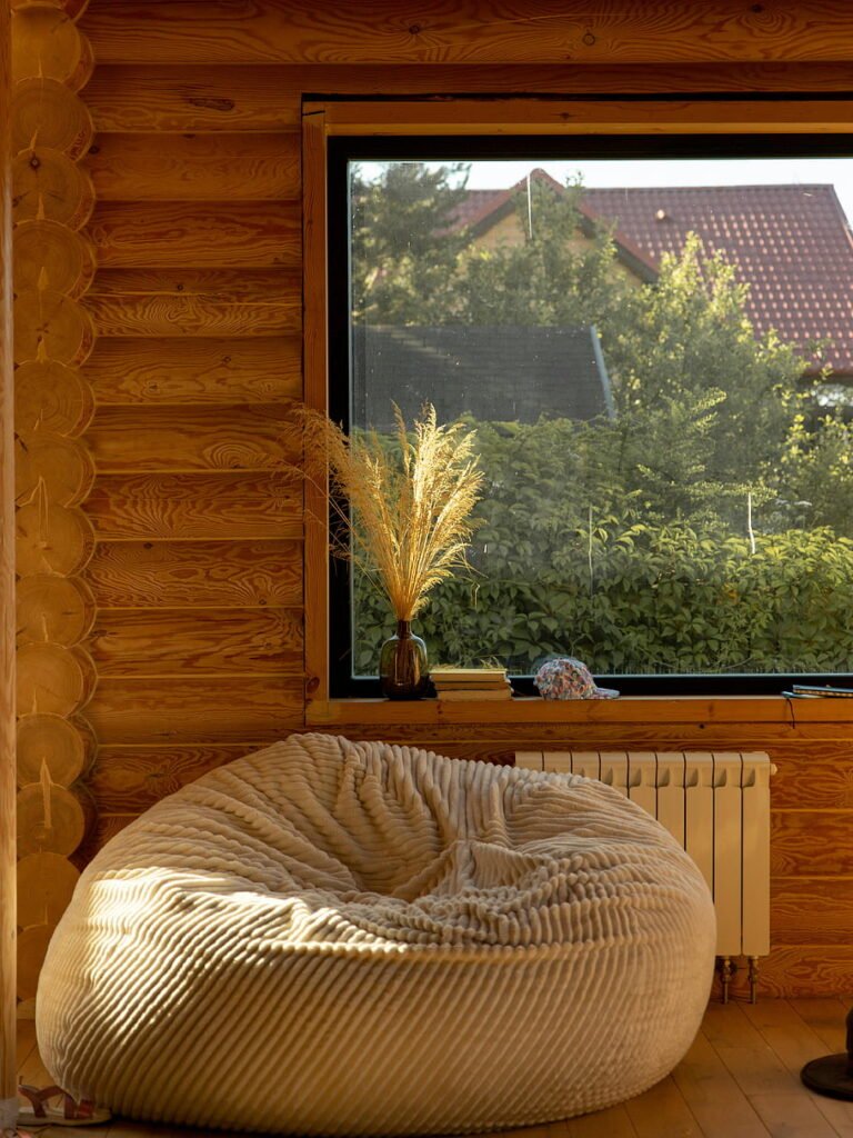 Cozy small living room with an oversized bean bag near a large window