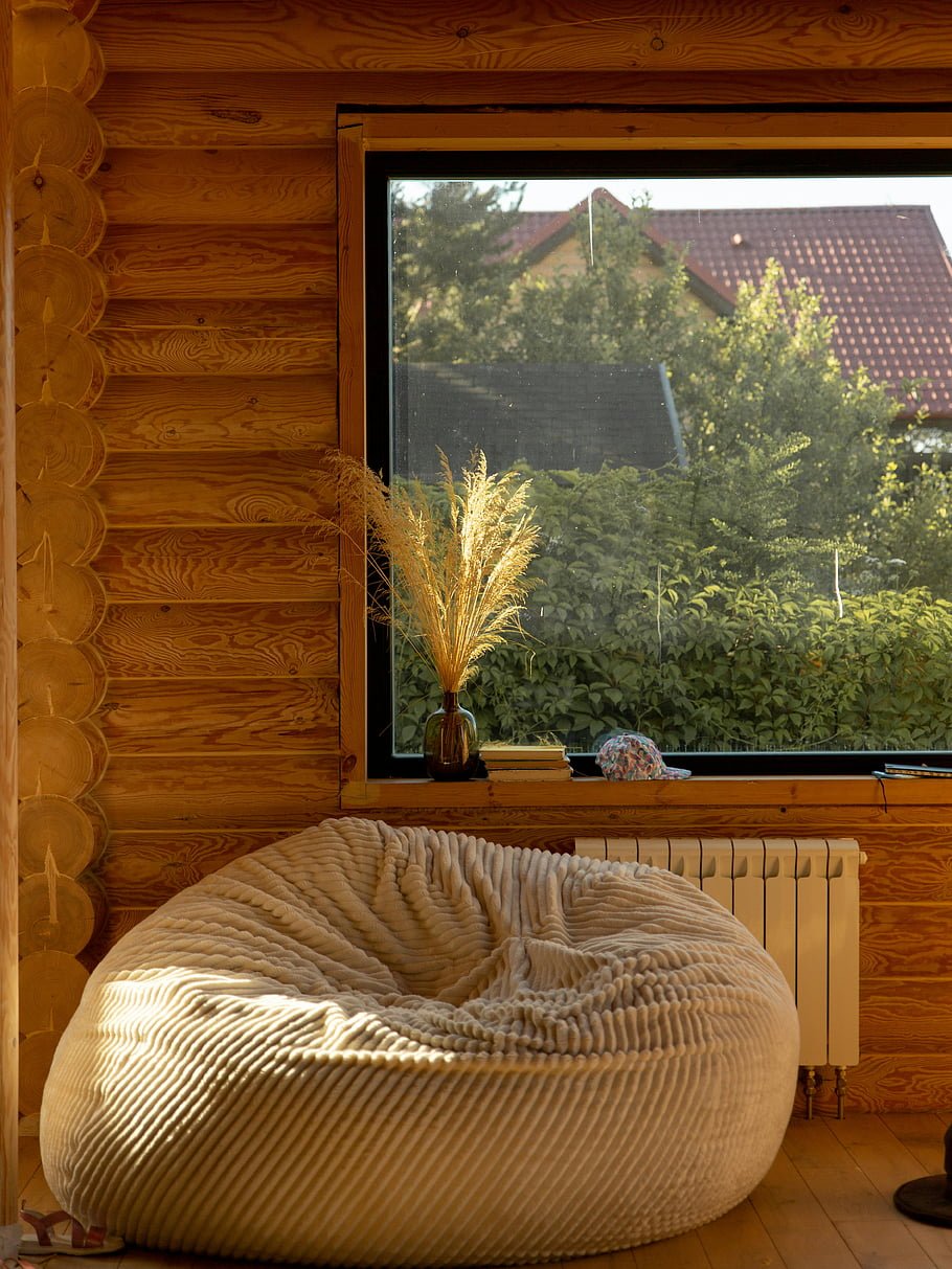 Cozy small living room with an oversized bean bag near a large window